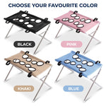 Four color options of the foldable pet grooming hammock stand in black, pink, khaki, and blue, each with a mesh hammock and silver folding frame.
