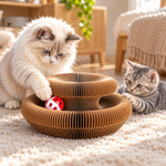 Two cats interacting with a foldable accordion cardboard cat scratcher and bell ball