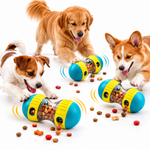 Three dogs interacting with yellow and teal interactive treat-dispensing dog toys with treats scattered on a white background.
