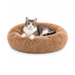 Round brown plush pet bed with a grey-and-white tabby cat resting inside.
