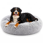 Grey round plush faux fur pet bed with a Bernese Mountain Dog resting on it.