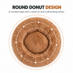 Top-down view of a brown round plush pet bed with circular arrows highlighting its round donut shape.

